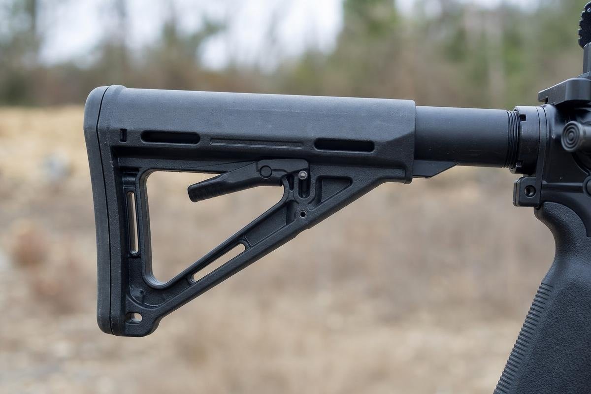 Close-up side view of a black collapsible AR-15 stock mounted on a buffer tube.
