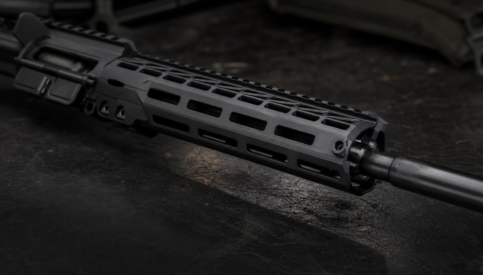 Close-up of a black anodized aluminum free-float M-LOK handguard installed on an AR-15 upper receiver with a low-profile gas block.