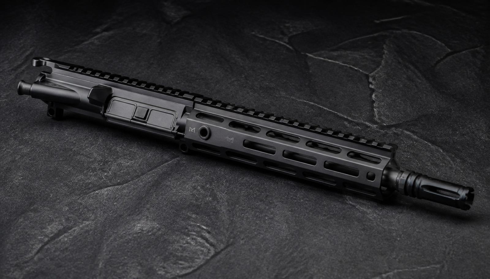A short-barreled AR-15 upper receiver with a 10.5 inch barrel, pistol-length gas system, and M-LOK free-float handguard on dark slate.