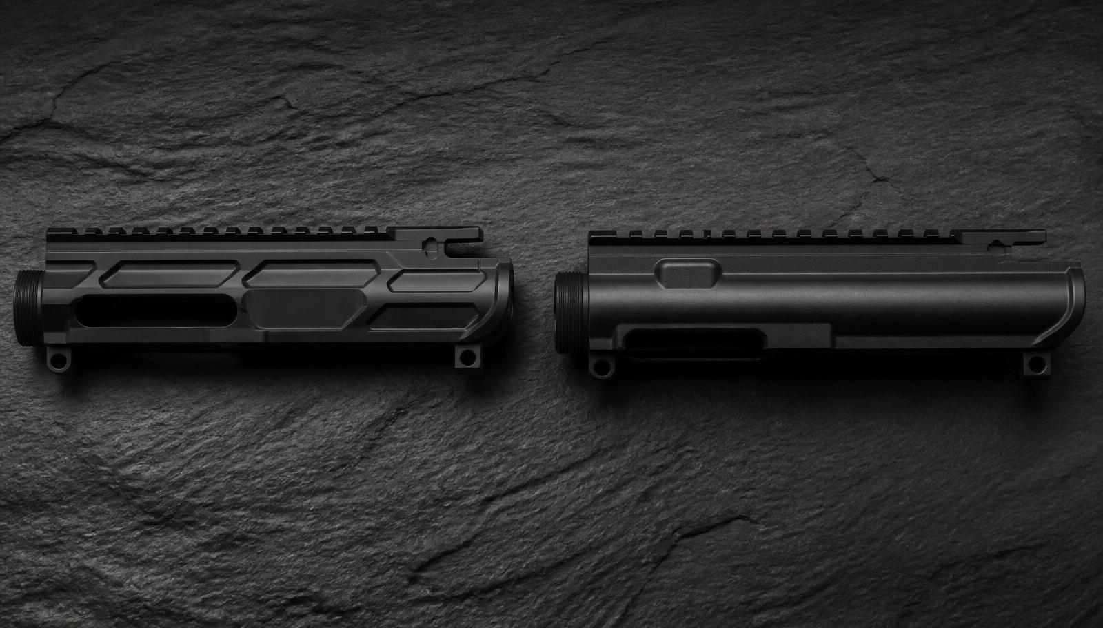 A billet AR-15 upper receiver with angular machined lines beside a rounded mil-spec forged upper on dark slate.